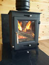 Ecosy Ottawa defra log burner in a cabin in Brighton