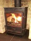 FDC 5kW defra log burner on a limestone hearth in Portslade